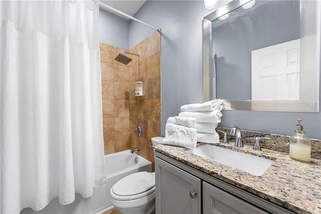 full bathroom with shower / bath combination with curtain, toilet, and vanity