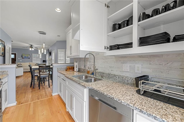 kitchen with dishwasher, white cabinets, sink, ceiling fan, and light wood-type flooring