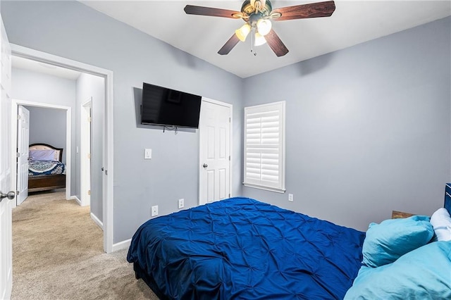 bedroom with ceiling fan and light colored carpet