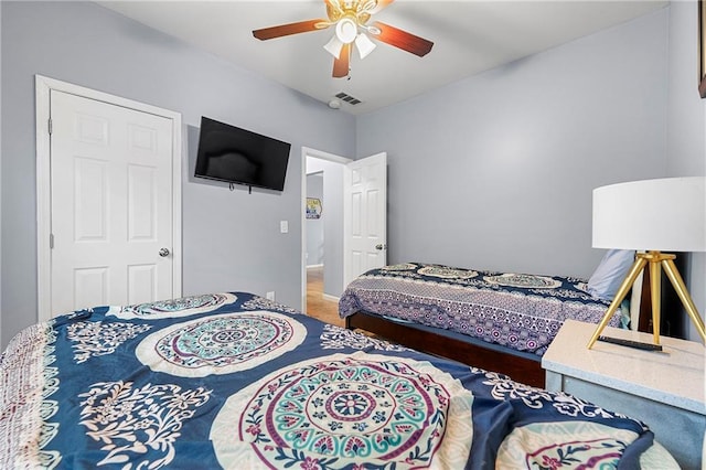 bedroom with hardwood / wood-style flooring and ceiling fan