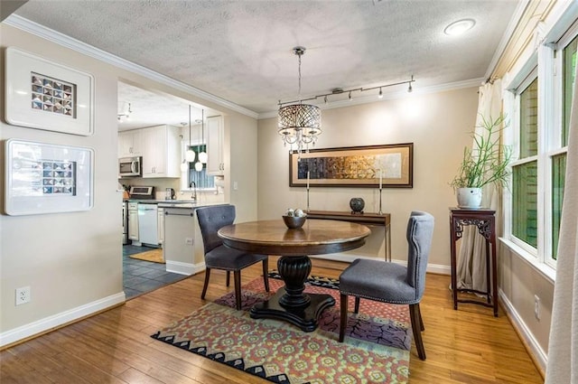 1071 Standard Dr NE, Brookhaven, GA 30319 - dining area featuring a chandelier, light wood finished floors, plenty of natural light, ornamental molding, and a textured ceiling