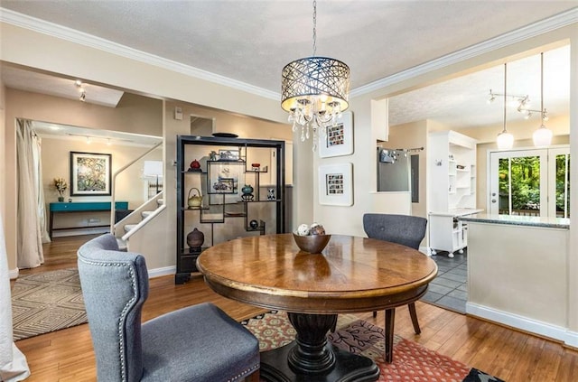 1071 Standard Dr NE, Brookhaven, GA 30319 - dining space featuring a chandelier, wood finished floors, stairway, baseboards, and ornamental molding