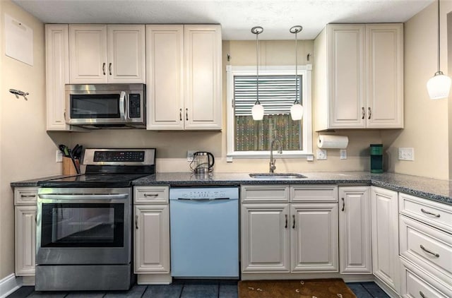1071 Standard Dr NE, Brookhaven, GA 30319 - kitchen featuring stainless steel appliances, a sink, decorative light fixtures, and dark stone counters