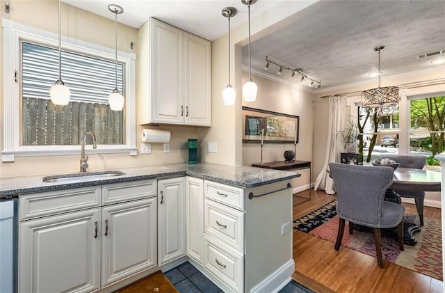 1071 Standard Dr NE, Brookhaven, GA 30319 - kitchen with a sink, dark wood-type flooring, a peninsula, stone counters, and hanging light fixtures