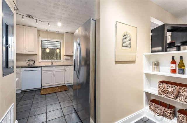 1071 Standard Dr NE, Brookhaven, GA 30319 - kitchen featuring dishwasher, stainless steel fridge, a sink, and white cabinets