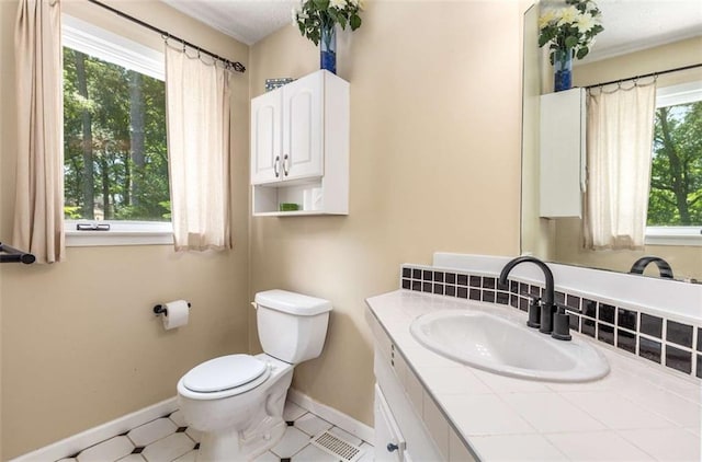 1071 Standard Dr NE, Brookhaven, GA 30319 - bathroom featuring baseboards, vanity, and toilet