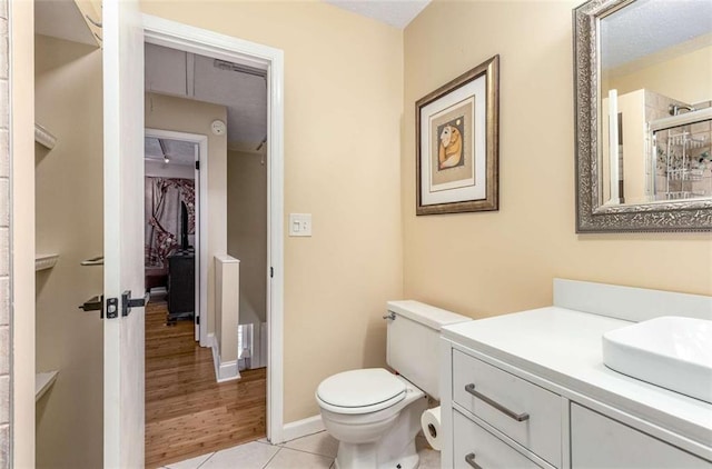 1071 Standard Dr NE, Brookhaven, GA 30319 - bathroom with toilet, vanity, tile patterned floors, a spacious closet, and baseboards