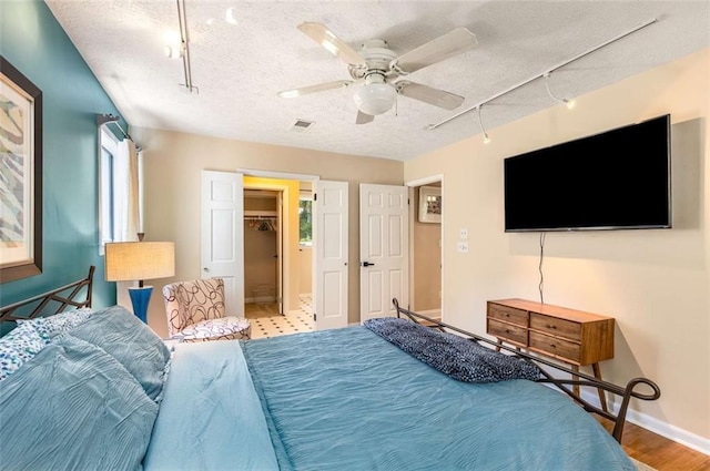 1071 Standard Dr NE, Brookhaven, GA 30319 - bedroom with track lighting, a textured ceiling, ceiling fan, and baseboards