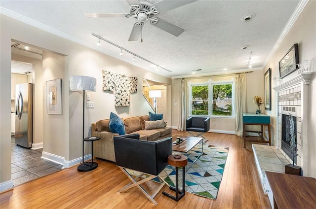 1071 Standard Dr NE, Brookhaven, GA 30319 - living area with track lighting, a textured ceiling, crown molding, wood finished floors, and baseboards