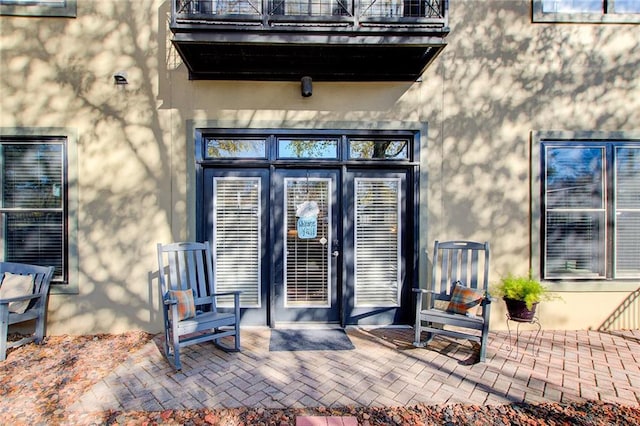 view of exterior entry with a patio