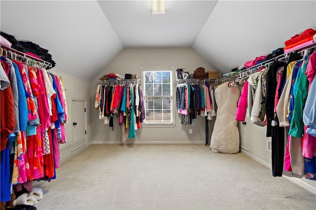 walk in closet featuring vaulted ceiling and carpet flooring