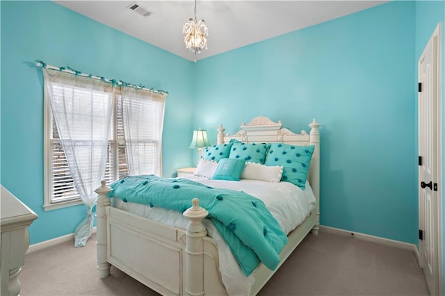 carpeted bedroom featuring visible vents, baseboards, and an inviting chandelier