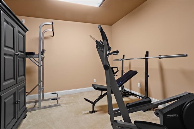 workout room with light colored carpet and baseboards