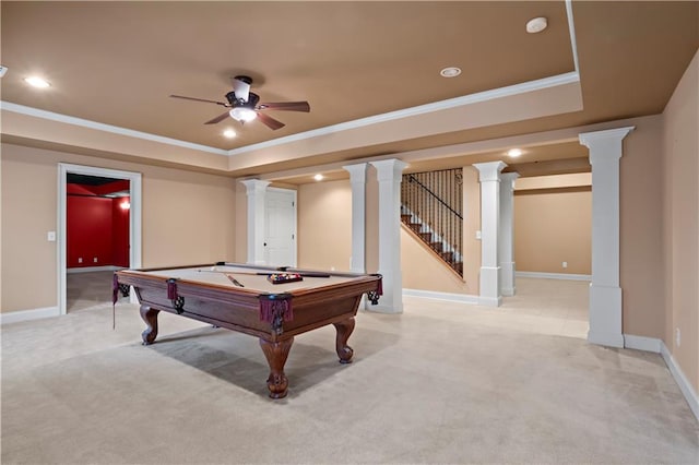 rec room featuring decorative columns, a tray ceiling, and light colored carpet