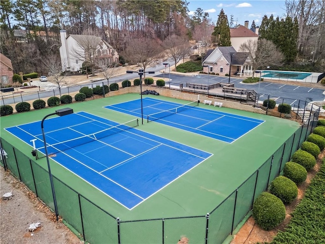 view of sport court featuring fence