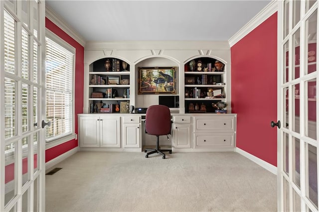 office with built in features, built in desk, visible vents, light carpet, and baseboards