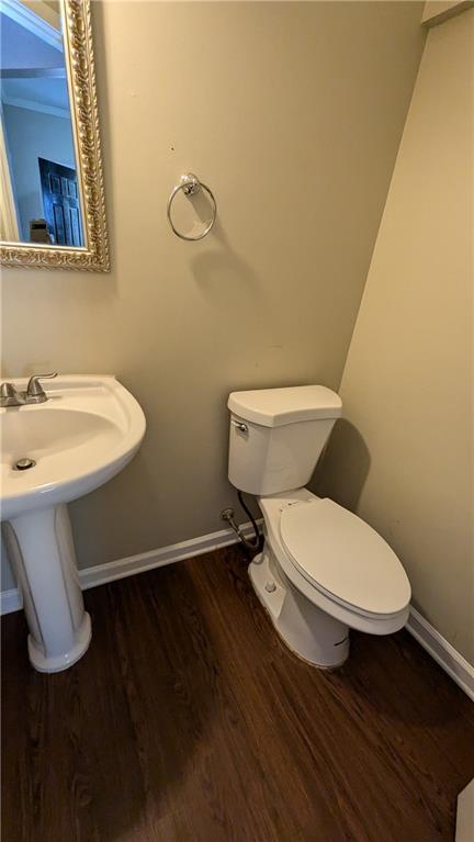 bathroom with toilet and wood-type flooring