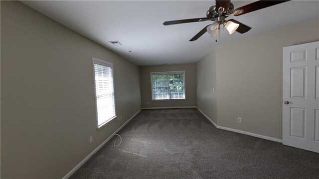 carpeted spare room with ceiling fan