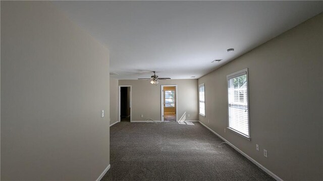 unfurnished room featuring carpet and ceiling fan