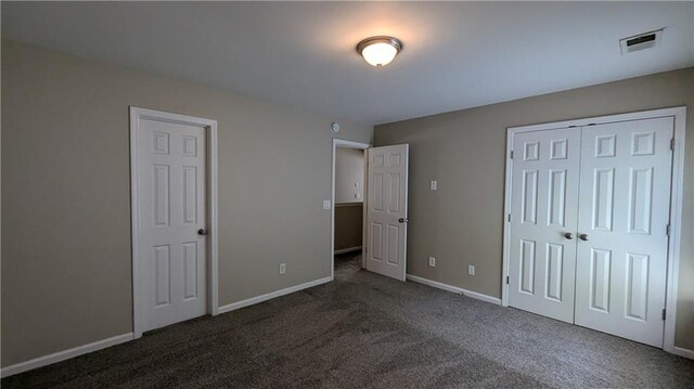 unfurnished bedroom featuring dark colored carpet