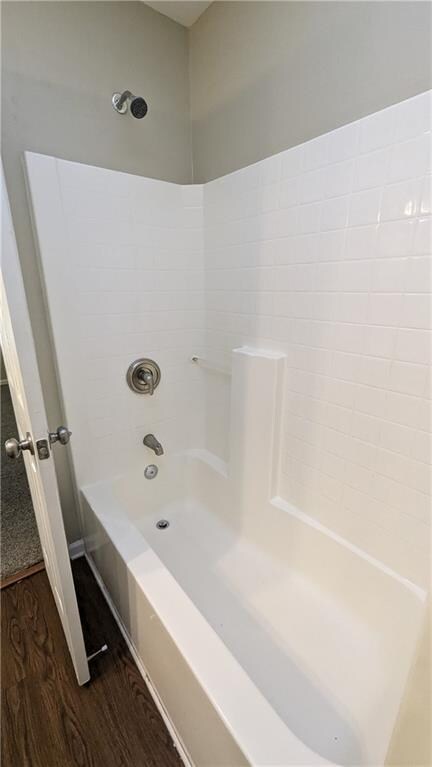 bathroom featuring shower / bathtub combination and wood-type flooring