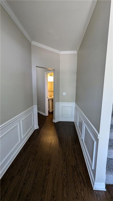 hallway with ornamental molding and dark hardwood / wood-style floors