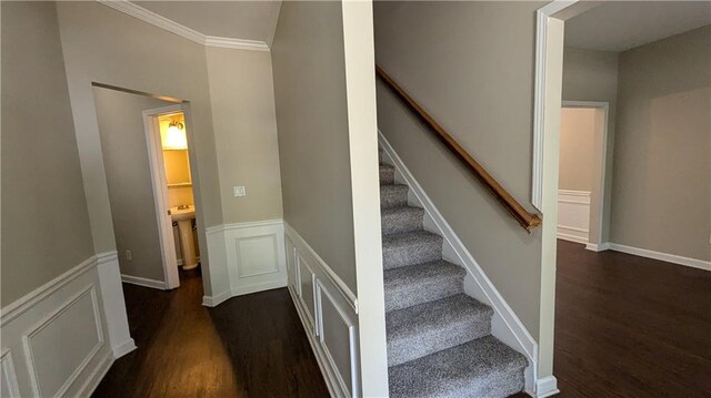 stairs with crown molding and hardwood / wood-style flooring