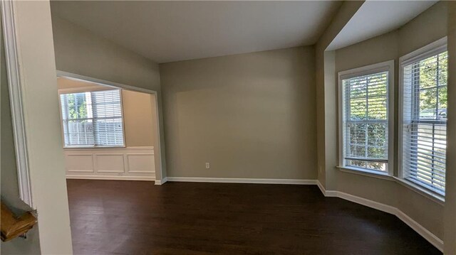 unfurnished room with dark hardwood / wood-style floors