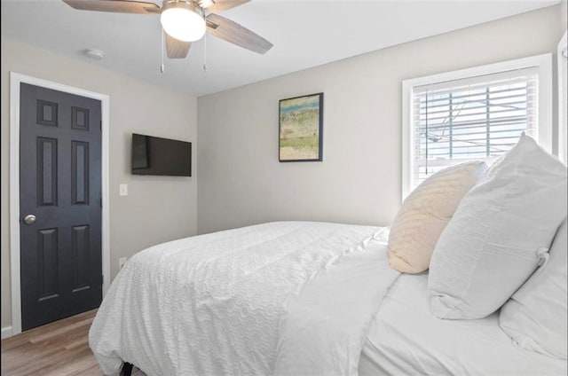 bedroom with light wood-type flooring and ceiling fan