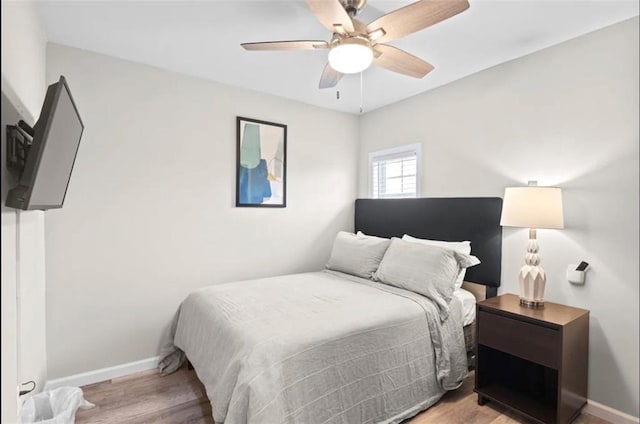 bedroom with ceiling fan and light hardwood / wood-style flooring