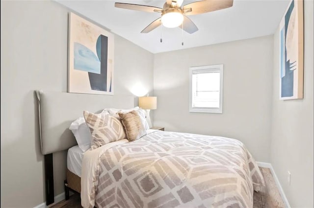 bedroom with hardwood / wood-style floors and ceiling fan