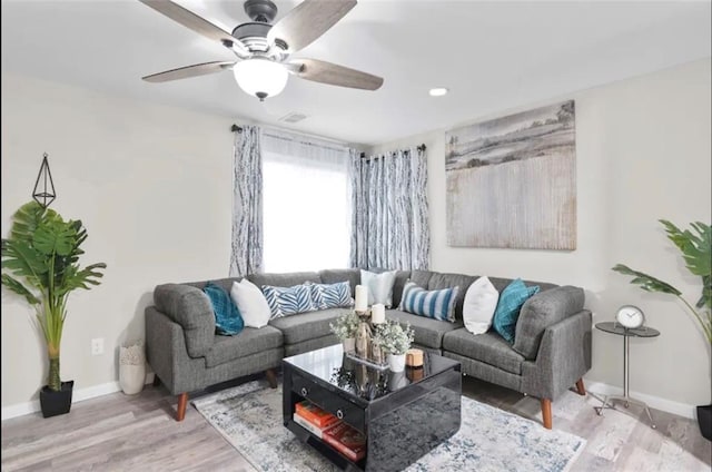 living room featuring ceiling fan and hardwood / wood-style flooring