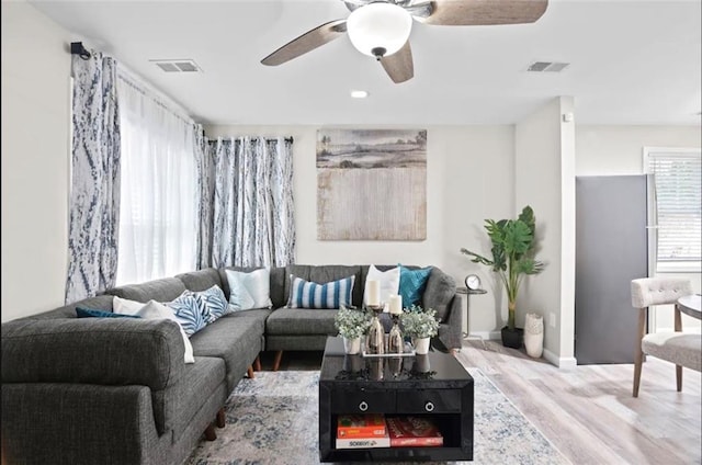 living room with hardwood / wood-style floors and ceiling fan