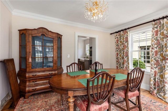 711 Greenview Ave NE, Atlanta, GA 30305 - dining space with ornamental molding, a chandelier, light wood-style floors, and baseboards