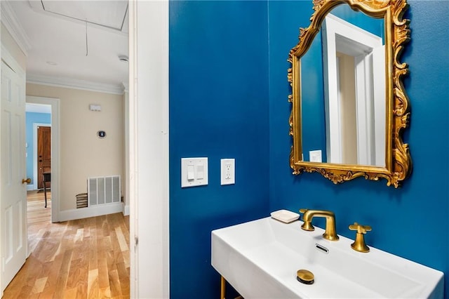 711 Greenview Ave NE, Atlanta, GA 30305 - bathroom with a sink, crown molding, and wood finished floors