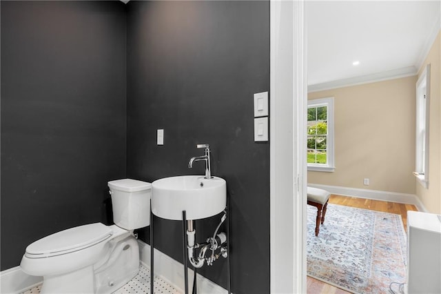 711 Greenview Ave NE, Atlanta, GA 30305 - half bath with a sink, toilet, baseboards, ornamental molding, and wood finished floors