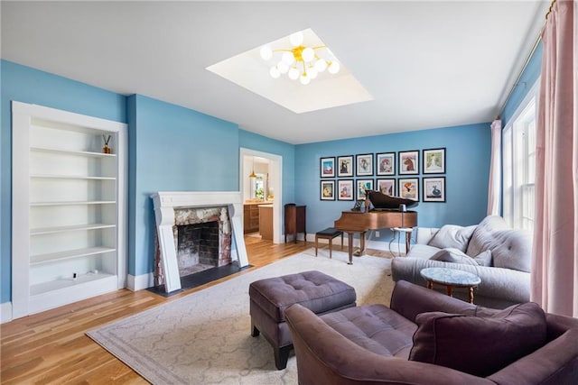 711 Greenview Ave NE, Atlanta, GA 30305 - living area with a skylight, wood finished floors, a premium fireplace, and baseboards