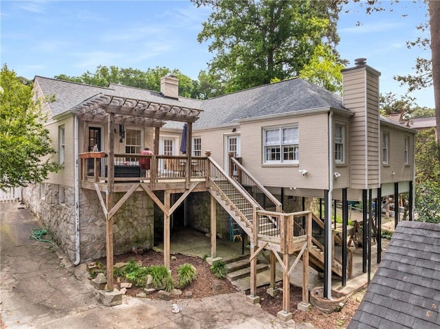711 Greenview Ave NE, Atlanta, GA 30305 - back of property with a chimney, stairway, a pergola, a shingled roof, and a deck