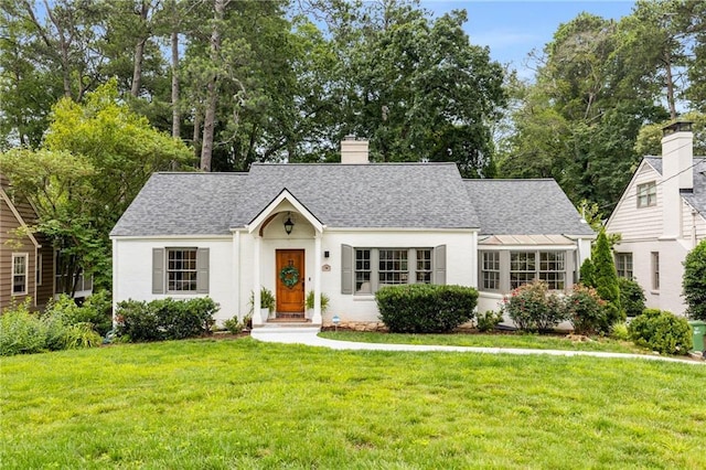 711 Greenview Ave NE, Atlanta, GA 30305 - view of front of house featuring a front lawn, a chimney, and roof with shingles