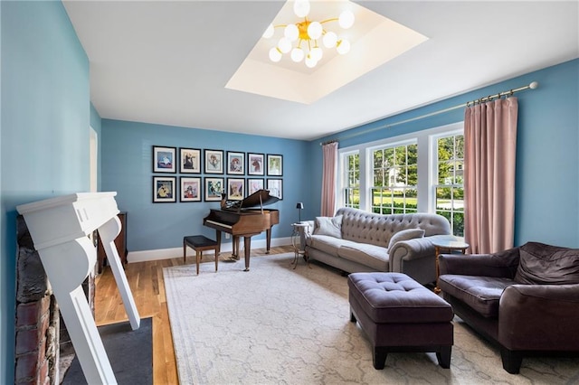 711 Greenview Ave NE, Atlanta, GA 30305 - living area with a skylight, wood finished floors, baseboards, and a chandelier