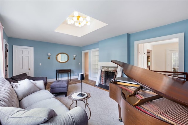 711 Greenview Ave NE, Atlanta, GA 30305 - living area with a skylight, baseboards, a premium fireplace, wood finished floors, and built in shelves
