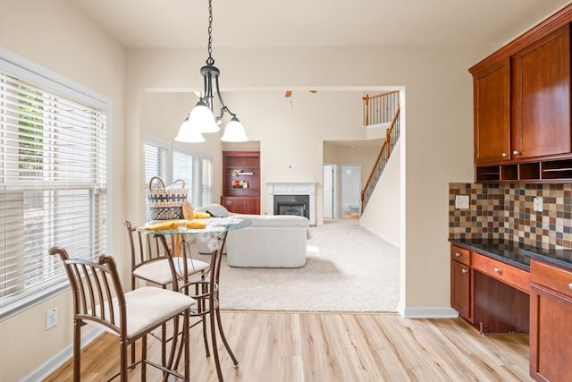 dining room with an inviting chandelier and light hardwood / wood-style flooring