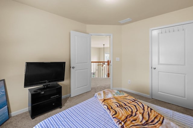 bedroom with light carpet and a closet