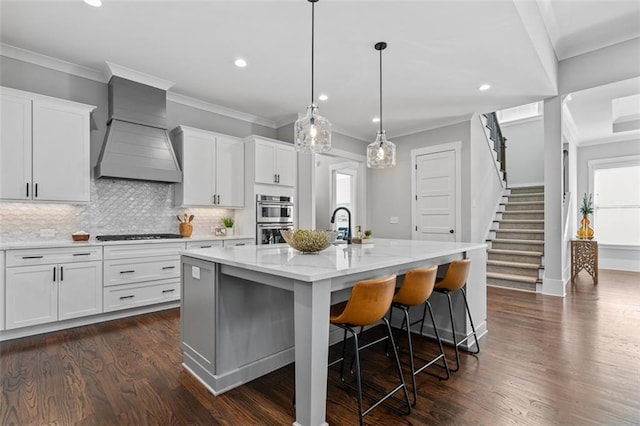 2208 Sage Mountain Ct SW, Marietta, GA 30064 - kitchen with custom exhaust hood, double oven, an island with sink, recessed lighting, and tasteful backsplash