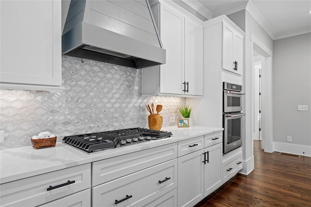 2208 Sage Mountain Ct SW, Marietta, GA 30064 - kitchen featuring premium range hood, appliances with stainless steel finishes, ornamental molding, white cabinets, and light stone counters
