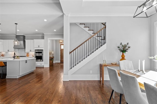 2208 Sage Mountain Ct SW, Marietta, GA 30064 - dining space featuring stairs, crown molding, dark wood-style floors, and recessed lighting