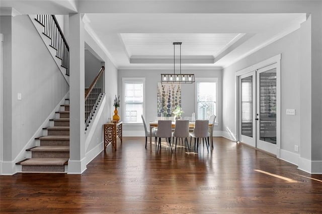 2208 Sage Mountain Ct SW, Marietta, GA 30064 - dining area with stairway, wood finished floors, a tray ceiling, a chandelier, and crown molding