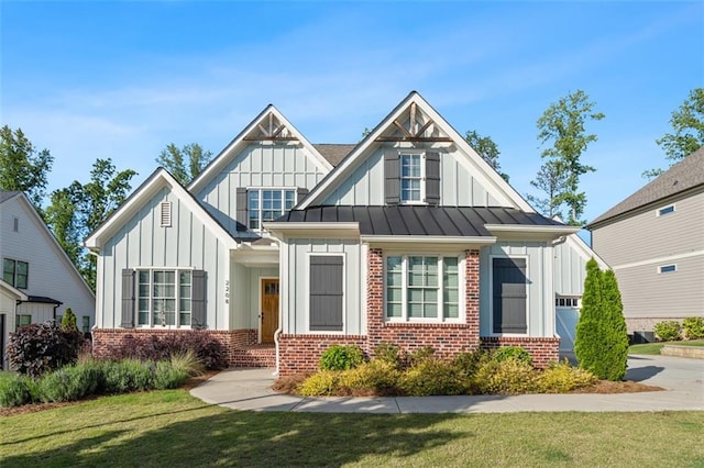 2208 Sage Mountain Ct SW, Marietta, GA 30064 - view of front of house featuring brick siding, board and batten siding, a front lawn, a standing seam roof, and a metal roof