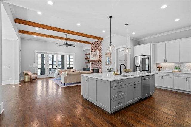 2208 Sage Mountain Ct SW, Marietta, GA 30064 - kitchen with stainless steel appliances, gray cabinets, a fireplace, recessed lighting, and white cabinets