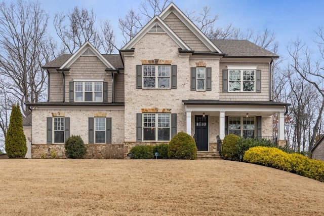 craftsman house featuring a front lawn and a porch